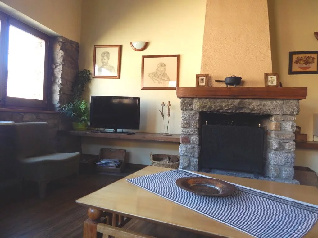 Llar de foc encesa a la sala d'estar de Cal Fuxet